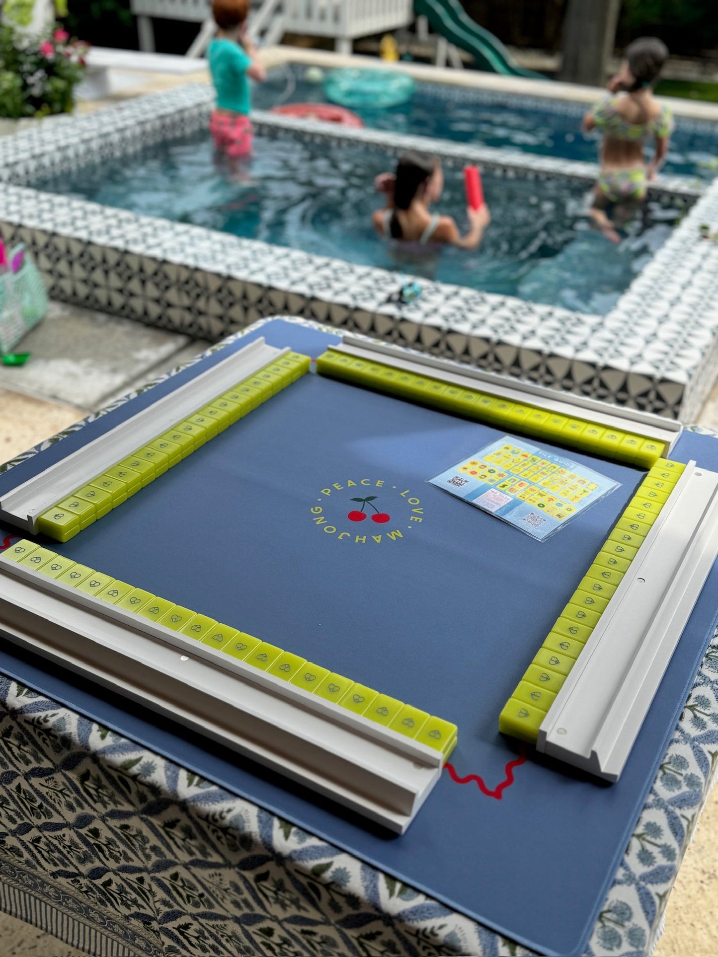 Mahjong racks and pushers set of 4 in use by a poolside table.