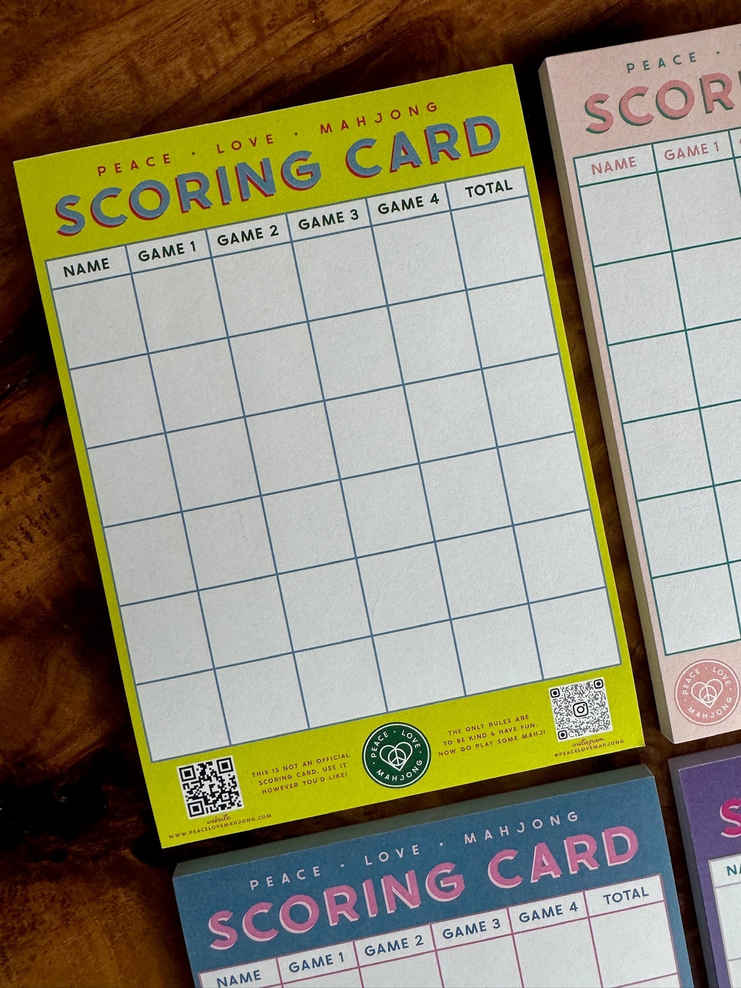 Mahjong Scoring Notepad with colorful design and score tracking grids.