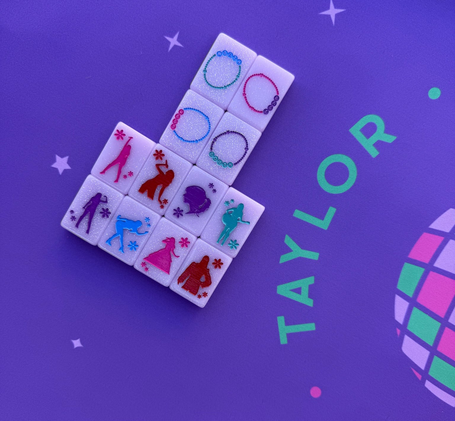 Taylor's Tiles Mahjong Set with colorful, stylized tiles on a purple background.
