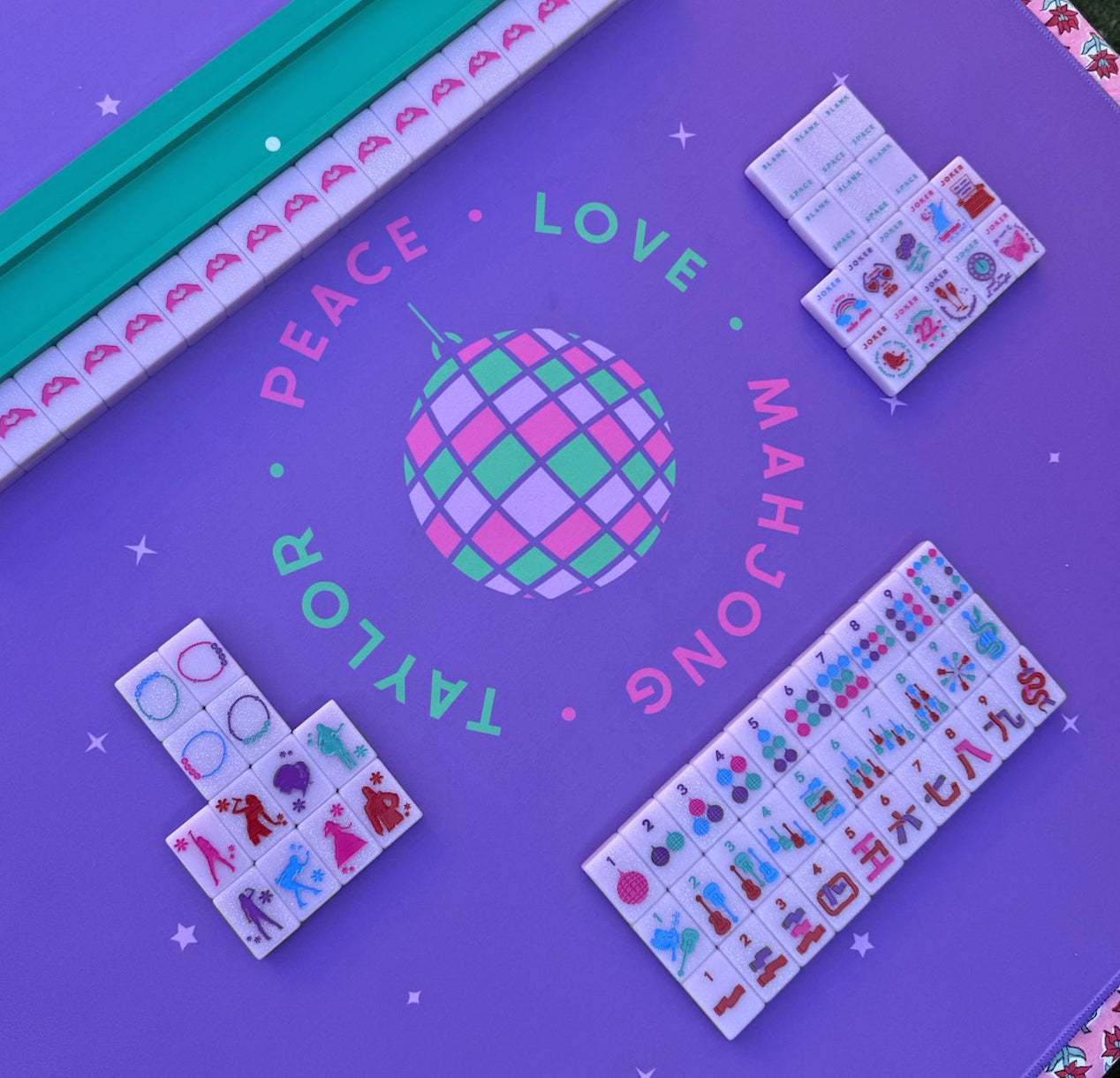 Colorful Mahjong set by Taylor's Tiles on a purple mat with uniquely designed tiles.