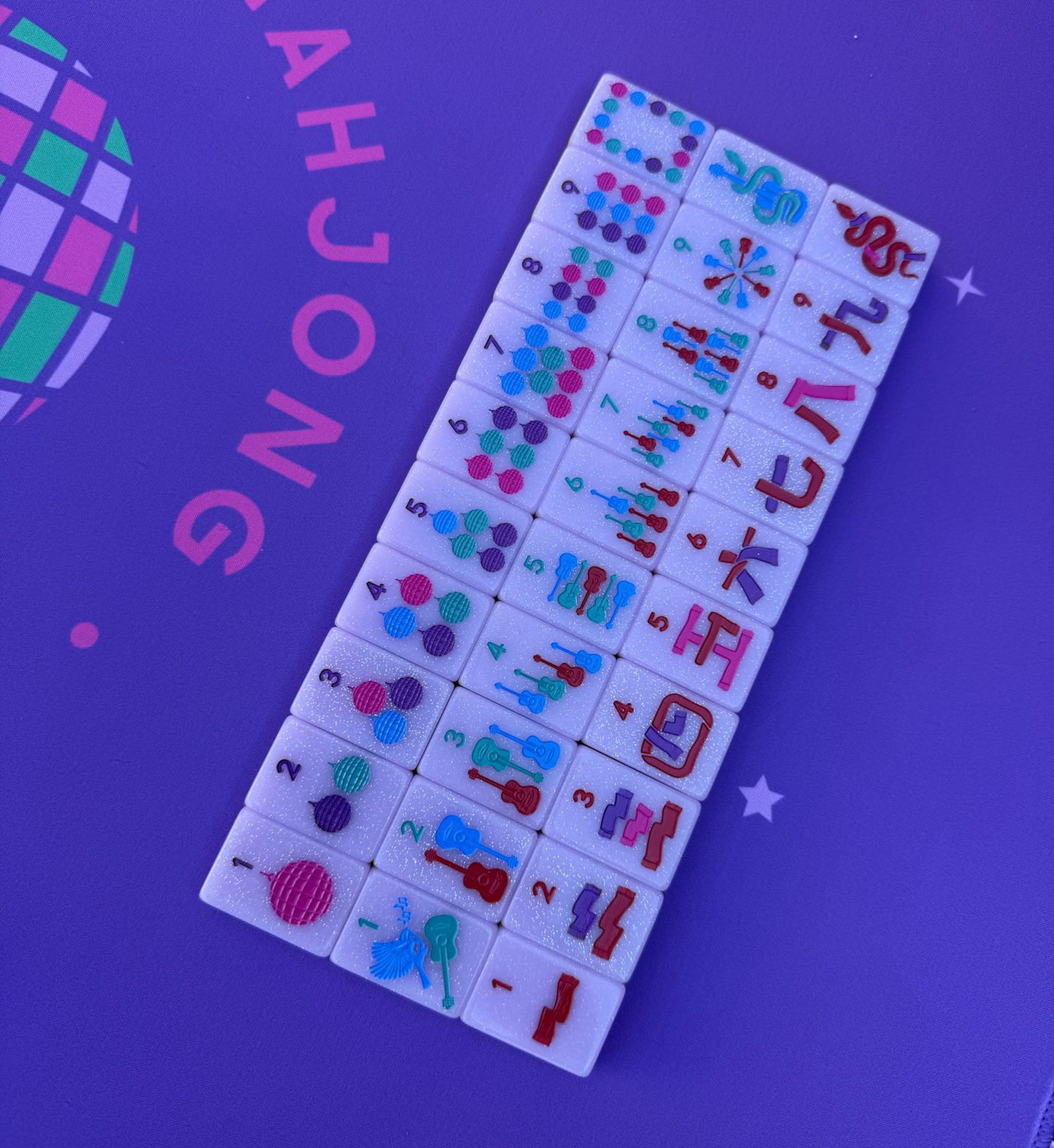 Mahjong tiles set from Taylor's Tiles displayed on a purple mat.