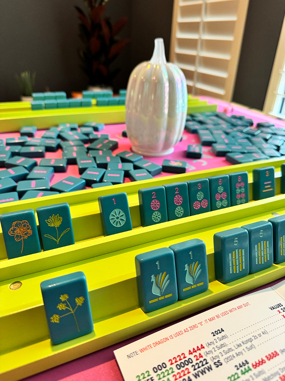 mahjong racks and pushers set with tiles on a table