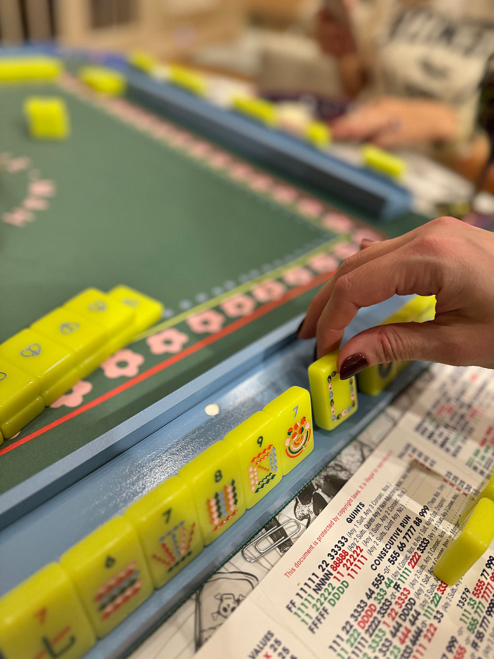 Mahjong racks and pushers set with tiles on a game board.