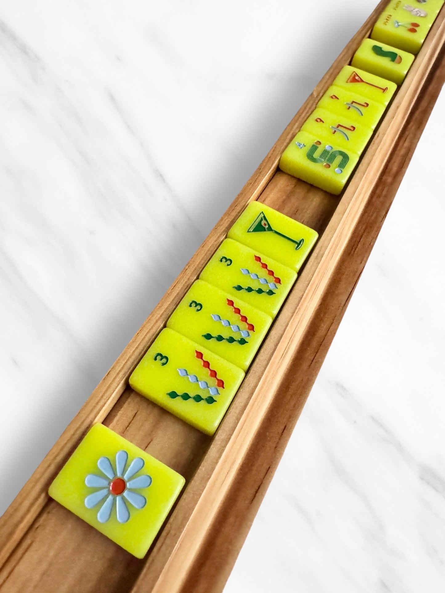Sleek mahjong racks and pushers set for larger tiles, available in oak and white.