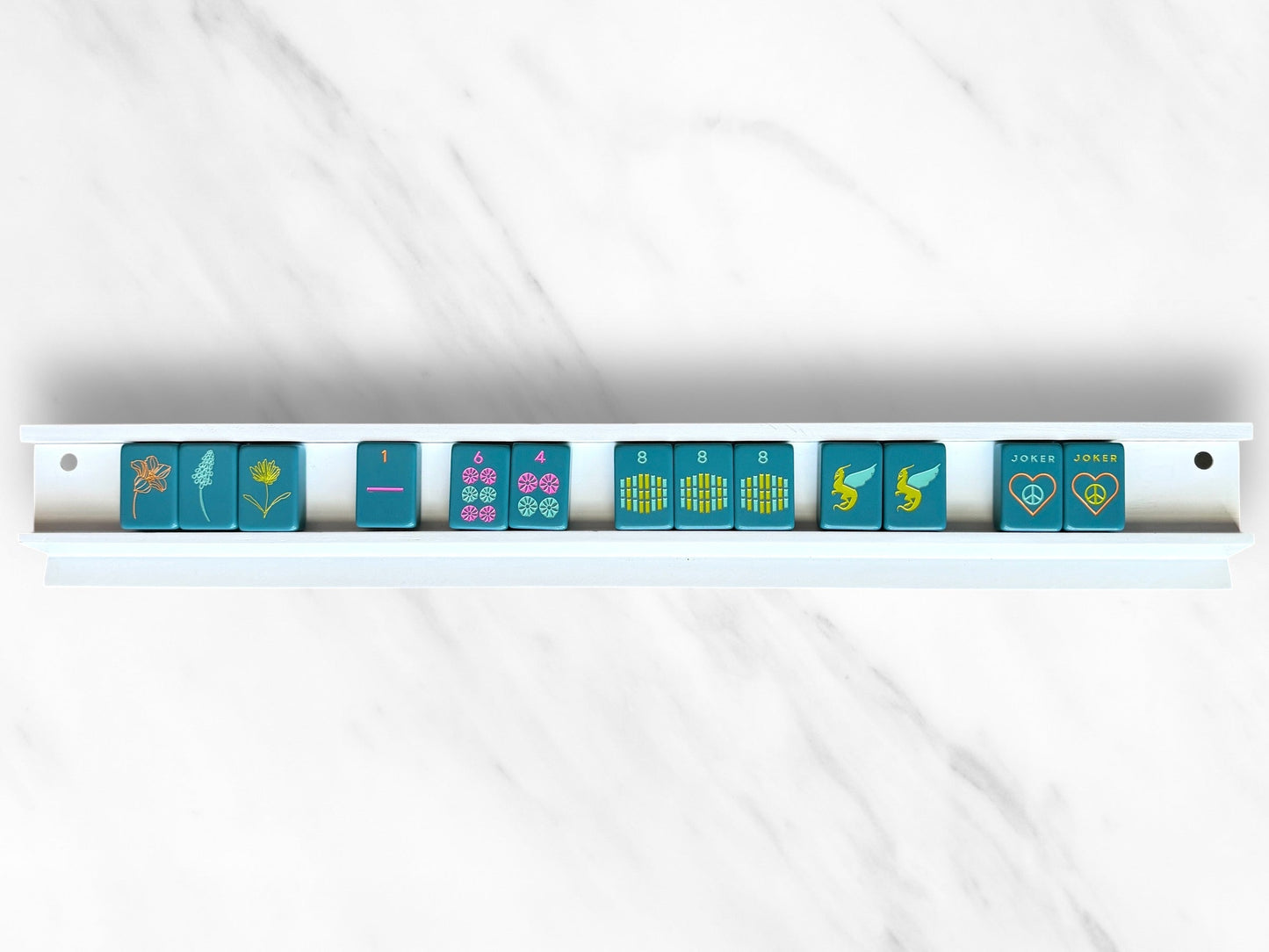 Mahjong rack with tiles in a sleek white design for larger tiles.